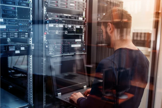 Engineer in data centre looking at lockable rack